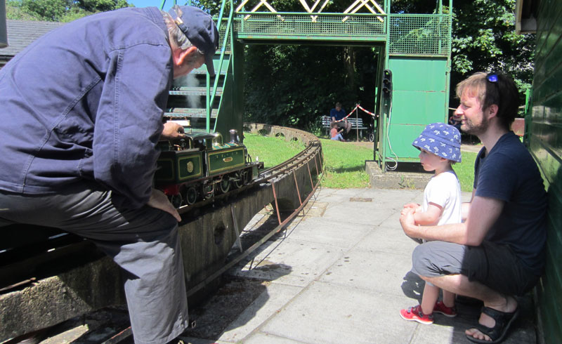 Classic photo of young boy looking at engine and driver